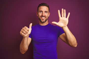 Fototapeta premium Young man wearing casual purple t-shirt over lilac isolated background showing and pointing up with fingers number six while smiling confident and happy.