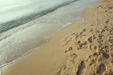 White wave at the sea and brown sand beach, summer concept background, Background with the copy space.