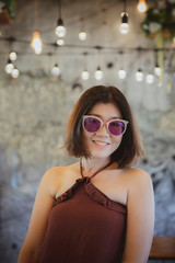 toothy smiling face of beuatiful asian woman relaxing in home living room