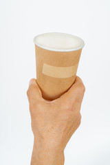 .man holding cardboard glass