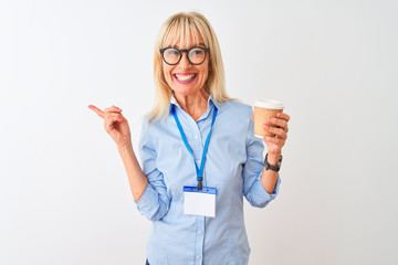 Businesswoman wearing glasses and id card drinking coffee over isolated white background very happy pointing with hand and finger to the side