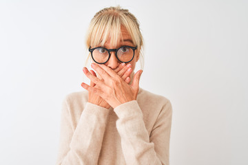Middle age woman wearing turtleneck sweater and glasses over isolated white background shocked...