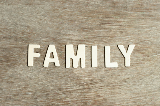 Alphabet letter in word family on wood background