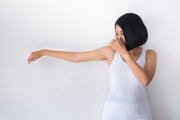 Asian woman with odor sweating,Female smelling or sniffing her armpit,Bad smell,Close up
