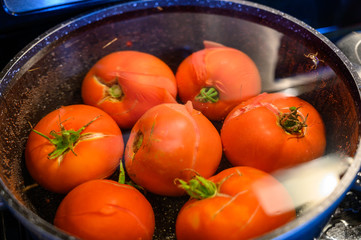 blanched tomatoes in boiling hot water