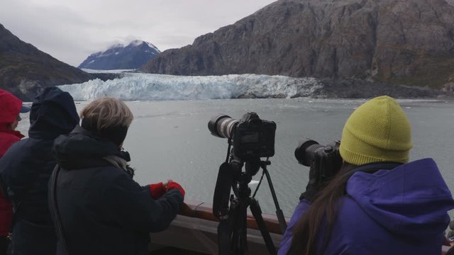 Cruise ship Alaska Glacier Bay Tourists and photographer looking at Margerie Glacier taking pictures on cruise ship using SLR cameras. People on vacation travel cruising famous destination.