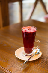 Hot vitamin fruit tea on wood table.