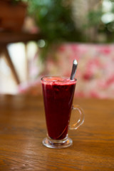 Hot vitamin fruit tea on wood table.