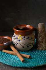 mexican cup of coffee with cinnamon on wooden background
