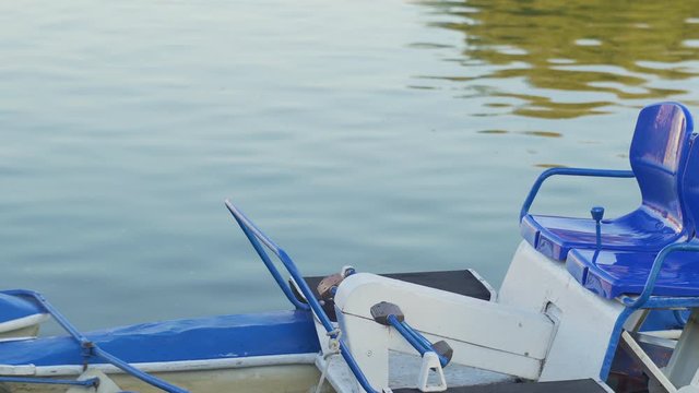 Blue catamarans on the waterfront. Catamaran rental. River and city water transport. Boat for travel vacation.