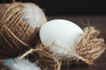 White chicken eggs and shell on a dark wooden background.
