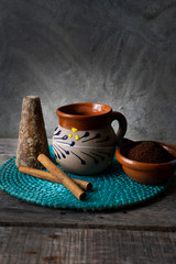 mexican cup of coffee with cinnamon on wooden background