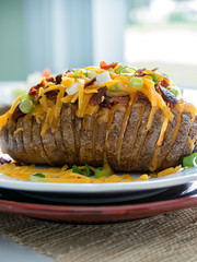 Potato Topped with Cheese and Bacon Closeup Vertical