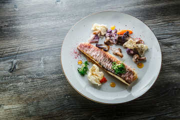 top view on modern decorated roasted fish fillet and vegetables