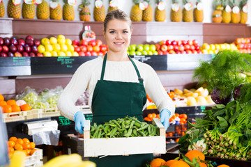 Salesgirl offering green beans