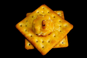Cracker cookies on dark background.