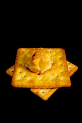 Cracker cookies on dark background.