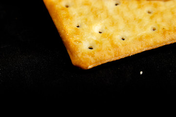 Cracker cookies on dark background.