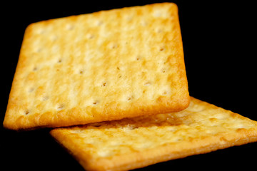 Cracker cookies on dark background.