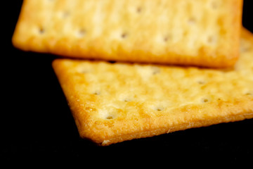 Cracker cookies on dark background.