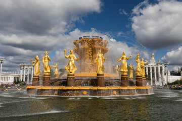 The Peoples Friendship Fountain in VDNKh park in Moscow. Amazing sunny view of the Soviet architecture, landmark of Moscow. Beautiful luxurious old fountain in summer.