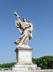 Fototapeta na wymiar Angel with the Cross at the Sant'Angelo bridge - Rome, Italy. Sculpture by Ercole Ferrata, 1610-1686. It has the inscription Whose government shall be upon His shoulder.