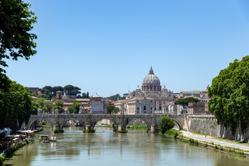Fototapeta na wymiar View of Sant'angelo bridge over the Tiber river with St. Peter's Basilica in background - Rome, Italy