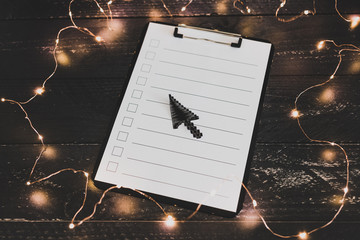 clipboard with blank list with cases to tick off on wooden desk with mouse pointer style icon
