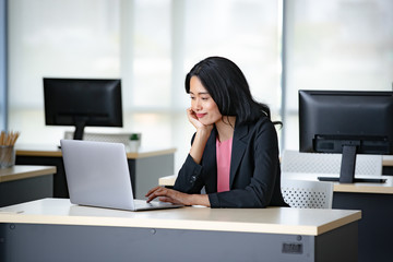 Asian businesswoman using notebook computer..