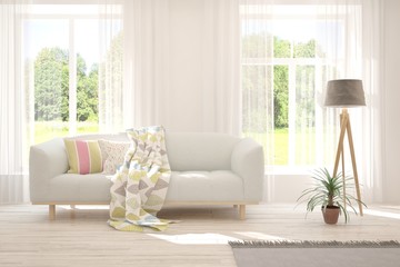 Stylish room in white color with sofa and summer landscape in window. Scandinavian interior design. 3D illustration