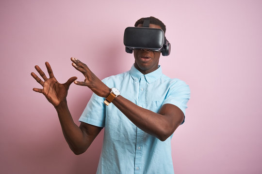 Young african american man playing virtual reality game using goggles