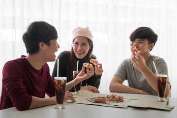 Group of friends eating pizza.