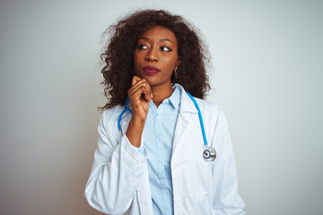 Young african american doctor woman wearing stethoscope over isolated white background with hand on...