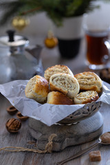 Oriental pastry made from puff pastry and wrapped in it a filling of sugar, butter and walnut. Armenian national pastry ghat or kyat with New Year's serving.. Selective focus