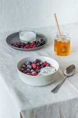 Granola with berries, yoghurt and honey. Raspberries, blueberries, currants.