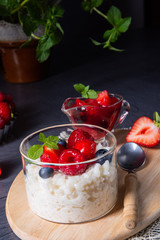 delicious milk rice with different berries and red fruit jelly