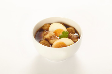 Asian food,hard-boiled egg in brown sauce or sweet gravy on white table, A kind of Chinese dish.