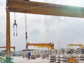 Precast concrete plant with blue sky and sun shining in the construction site, in storage yard area at Thailand, Space for text in template, Concrete Tunnel Segments