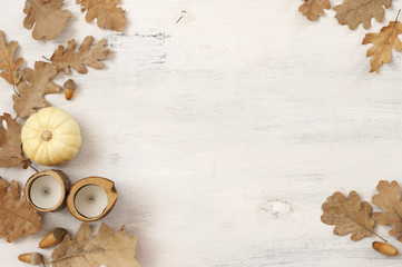 Autumnal still life with oak leaves, acorns, pumpkin and candles