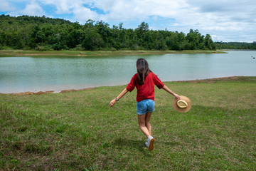 Beautiful young woman enjoying sun and fresh air in a field,happy day