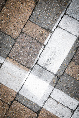 white painted road markings on a stone for a abstract background 