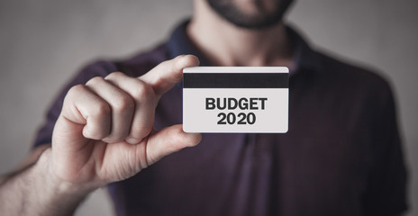 Man holding credit card. Budget 2020