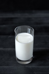 glass milk on black background
