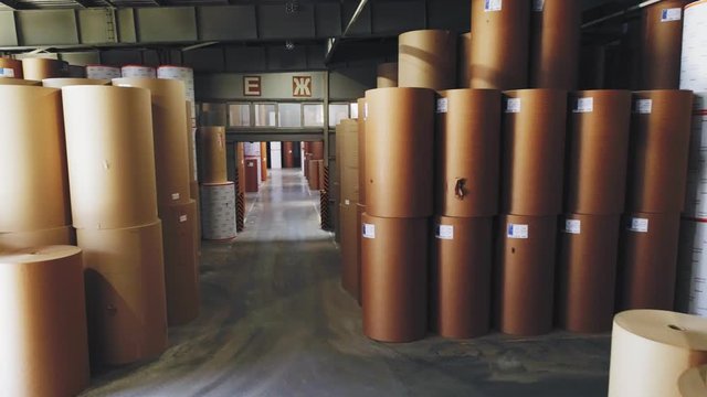 paper rolls stacked in light spacious warehouse at plant
