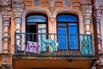Fototapeta na wymiar Angle of antique building with balcony and clothes on it