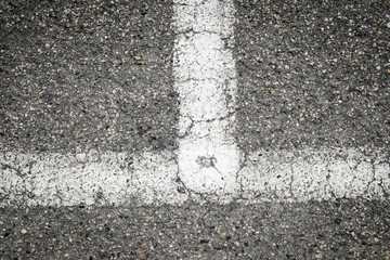 Fototapeta premium white painted road markings on a gray pavement for a background 