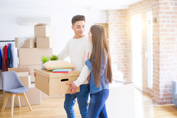 Beautiful young asian couple looking happy and smiling excited moving to a new home