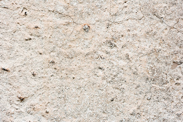 Texture of a concrete wall with cracks and scratches which can be used as a background