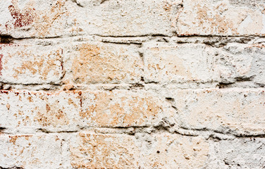 Texture of a brick wall with cracks and scratches which can be used as a background