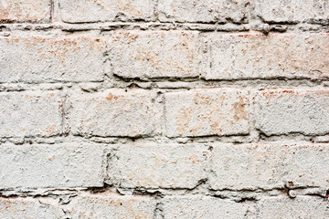 Texture of a brick wall with cracks and scratches which can be used as a background